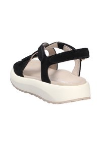 Sandali neri in suede con suola a piattaforma, cinturini regolabili e soletta imbottita. Presentano un interno beige liscio e una suola testurizzata.