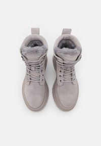 Gray suede ankle boots with faux fur lining, round toe, lace-up front, and pull tab. Textured rubber sole with slight elevation.