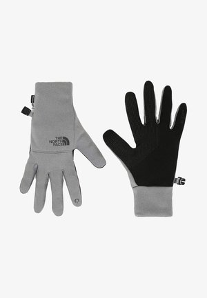 Guantes grises con acentos negros, hechos de material suave. Presentan un agarre texturizado en la palma y un puño ajustable para un ajuste seguro. Logo en el lateral.