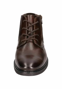 Bottines en cuir marron avec une finition lisse, dotées d'un laçage à l'avant, d'une fermeture éclair sur le côté et d'un bout arrondi. Semelle plate en caoutchouc noir.