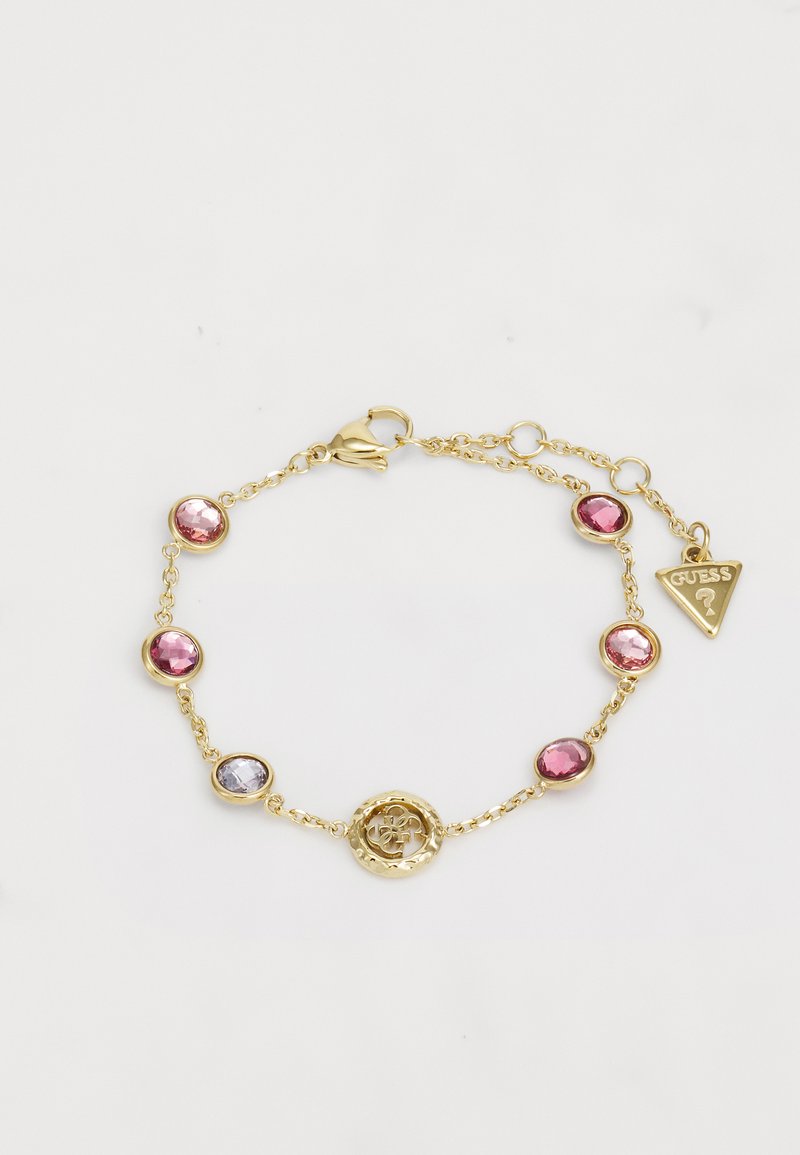 Gouden armband met een schakeldesign, ronde roze en paarse stenen, en een decoratieve cirkelvormige hanger met bloemdetail.