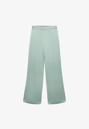 Pantalon large vert clair avec un tissu légèrement texturé et une ceinture élastique en forme de V, posé à plat sur un fond blanc.