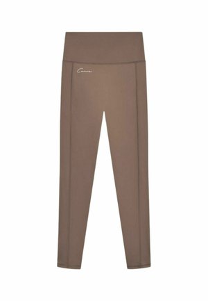 Brune leggings med høj talje med en lille hvid logo på venstre hofte mod en hvid baggrund.