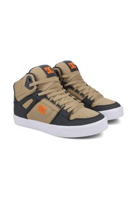 High-top sneakers featuring a tan and navy color scheme, synthetic material, perforated detailing, and a white rubber sole. DC logo in orange.