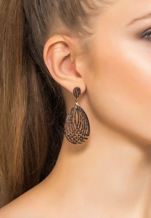 Black and gold teardrop earrings with an intricate layered design, featuring a curvy shape and embedded gemstone accents.