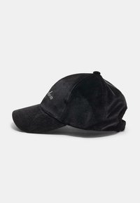 Black velvet baseball cap with a curved brim, featuring embroidered text on the front and an adjustable strap at the back.
