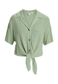 Blusa corta de manga corta y botones en un verde claro con un lazo en la parte delantera. Tejido texturizado y cuello clásico. Botones decorativos de color marrón.