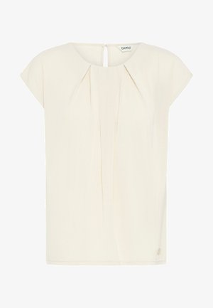 Ivory blouse with short cap sleeves, pleated front detail, keyhole back opening, and a small logo accent near the hem. Lightweight fabric.