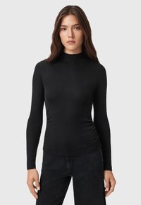 Maglione aderente nero a maniche lunghe con collo a roulè, caratterizzato da un design fitted e un discreto logo sulla parte sinistra del petto. Realizzato in materiale morbido ed elastico.