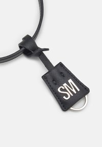 Black leather keychain with a textured finish, featuring a rectangular tag embossed with "SM" in silver, attached to a ring.