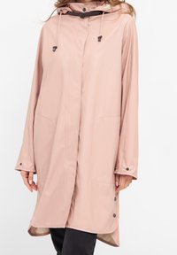 Pink raincoat with a hood, front snap closure, drawstring, and side pockets. Featuring long sleeves and a smooth, water-resistant fabric.
