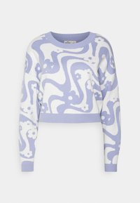 Cropped sweater in white with a lilac abstract floral design. Features long sleeves and a ribbed neckline and cuffs. Soft knit texture.