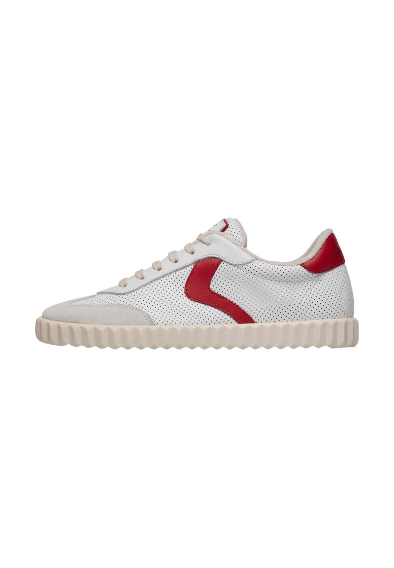 Sneaker with white perforated leather upper, red suede accents, and beige textured rubber sole. Features flat laces and a round toe design.