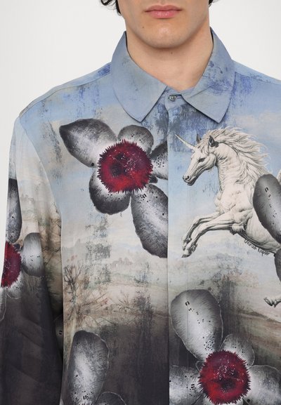 Button-up shirt featuring a blue background with large gray petals and red centers, adorned with a white unicorn graphic and artistic textures.