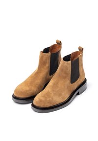 Tan suede Chelsea boots with elastic side panels, pull tab, and a low black rubber heel, featuring a smooth, matte texture.