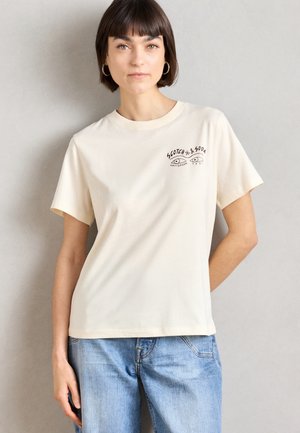 Crème-kleurige katoen t-shirt met korte mouwen en een ronde halslijn, voorzien van een zwart grafisch ontwerp op de borst.