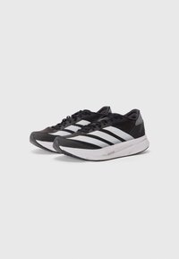 Black running shoes with grey accents, featuring a mesh upper, three white stripes, and a textured rubber sole. Lightweight design.