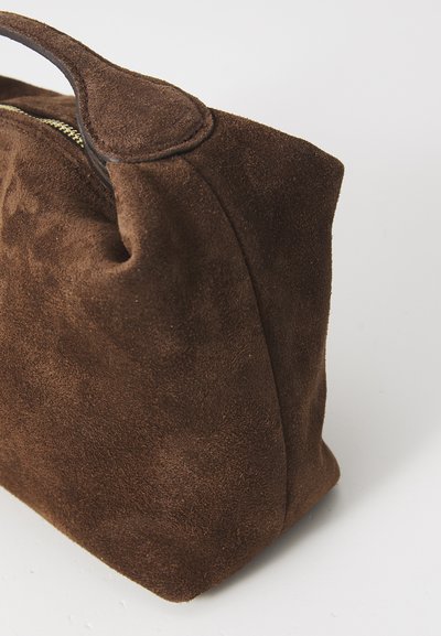 Brown suede handbag with a rounded shape, a stitched handle, and a zip closure, showcasing a soft texture and consistent color throughout.