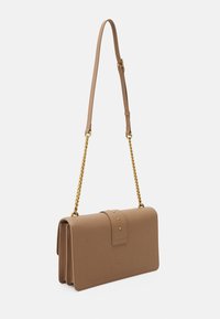 Beige leather crossbody bag with a gold chain strap, rectangular shape, front flap with stud accents, smooth texture, minimalistic design.