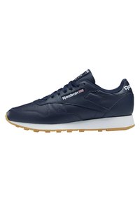 Tamsiai mėlyni odiniai sportbačiai su balta vidine suteikimo dalimi ir guminiu išoriniu padu. Ypatingos savybės: raišteliais surišamas priekis ir Reebok logotipas šone.
