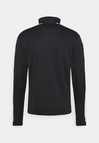 Schwarze Langarmjacke mit hohem Kragen, glatter Textur und weißen Seitenstreifen als Kontrast. Rückseite schlicht ohne weitere Details.