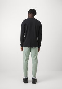 Nike Performance FLEX REP - Tepláky - jade horizon