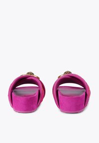 Fuchsia slide sandals with wide, curved straps and textured fabric. Features a gold accent on the top, cushioned footbed, and flat sole.