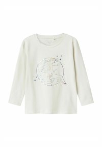 Camisa de algodón blanca de manga larga con un gráfico de unicornio holográfico en un diseño circular, acentuado por pequeñas estrellas.