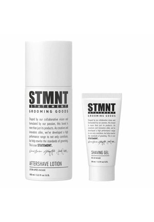 Aftershave lotion in a tall white bottle with black text, alongside a smaller white tube of shaving gel, both featuring minimalistic design.