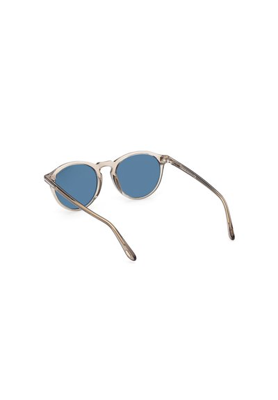 Runde Sonnenbrillen mit einem transparenten beigen Rahmen und blauen Gläsern. Schlanke, leicht gebogene Bügel. Minimalistisches Design ohne auffällige Texturen.