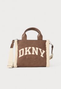 Brown suede handbag with cream faux shearling accents, double top handles, detachable strap, and front logo featuring "DKNY NEW YORK."