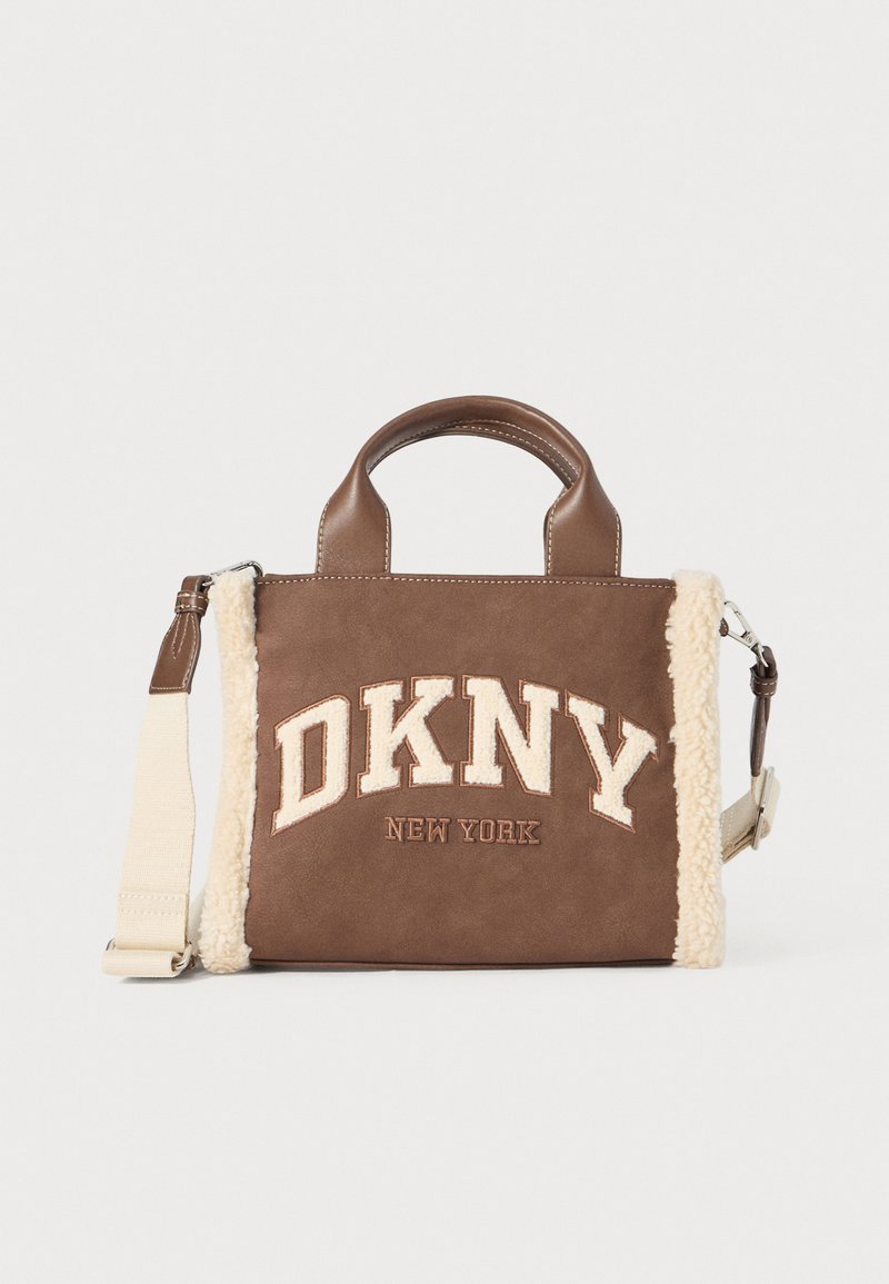 Brown suede handbag with cream faux shearling accents, double top handles, detachable strap, and front logo featuring "DKNY NEW YORK."