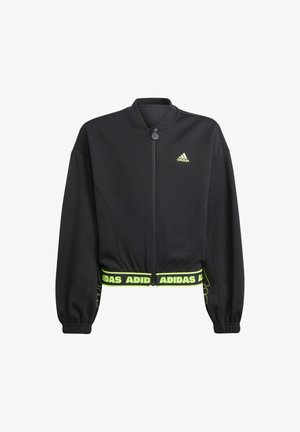 Giacca Adidas cropped nera con zip frontale, polsini elasticizzati e logo Adidas verde neon sul petto e sull'orlo. Texture del tessuto liscia.