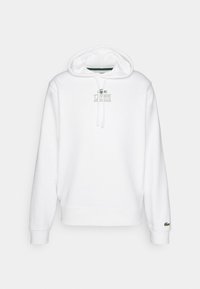 Balta šviesa su gobtuvu, raišteliais ir siuvinėtu "LACOSTE" logotipu. Yra įvairių garstyčių ir apykaklės detalių. Minkšta medvilnės medžiaga.