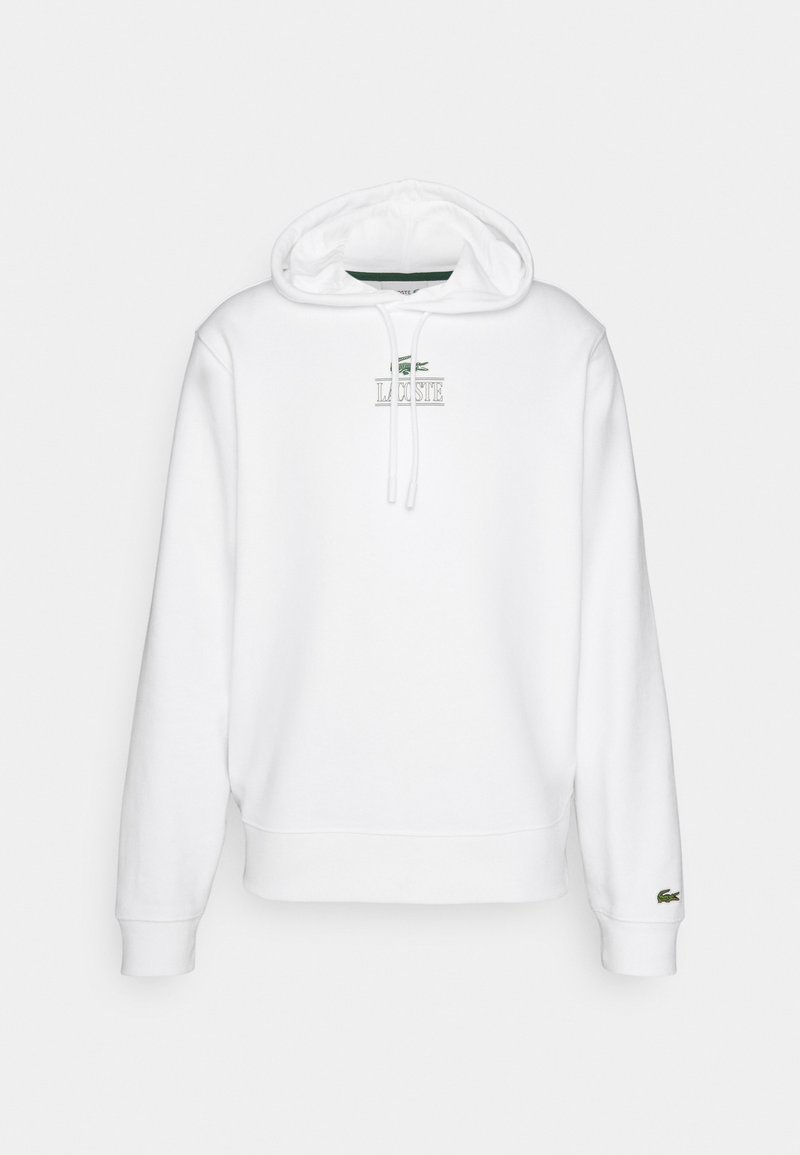 Sweatshirt blanc avec capuche, cordons de serrage et logo "LACOSTE" brodé. Présente des poignets et un ourlet en côte. Matériau en coton lisse.