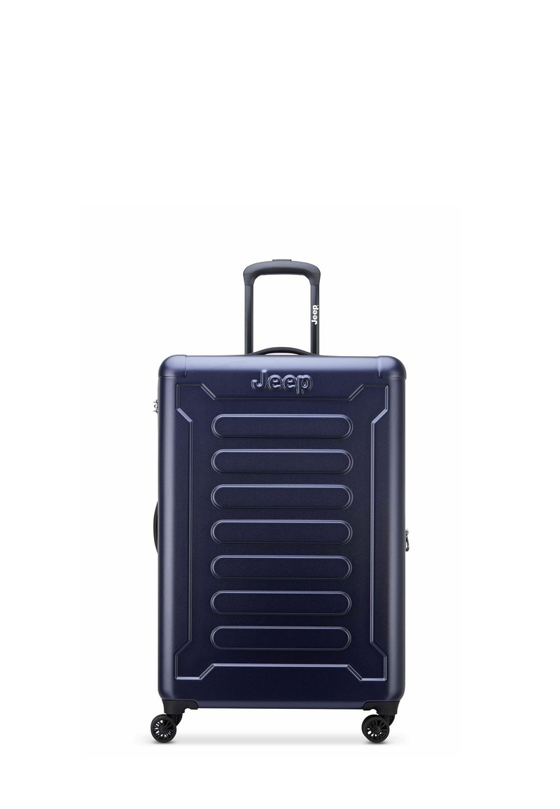 Valigia rigida blu navy con superficie texture, dotata di manico telescopico e quattro ruote per la mobilità. Logo "Jeep" visibile.