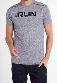 Grå atletisk t-shirt i strukturerad tygkvalitet, med en svart "RUN" grafisk design över bröstet och en ljusblå accentlinje.