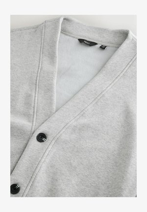 Világosszürke kardigán, puha anyagból készült, V-nyakú, fekete gombokkal és sima felülettel, amely tökéletes rétegezéshez.