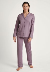 Lavender long-sleeve pajama set with contrasting white piping, featuring a button-up shirt and matching pants, made from soft fabric.