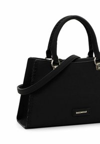 Black handbag with dual top handles, a crossbody strap, and a structured shape. Features stitched detailing and a gold logo accent.