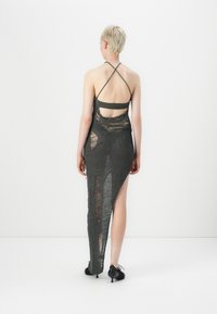 Gray, mesh-knit dress with a long side slit and open back. Features thin crisscross straps and distressed detailing.