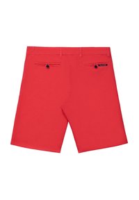 Röda shorts i bomull med en mjuk textur. Har två bakfickor, knappdetaljer och en etikett på den högra bakfickan.