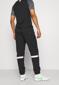 Nike Performance Träningsbyxor - black