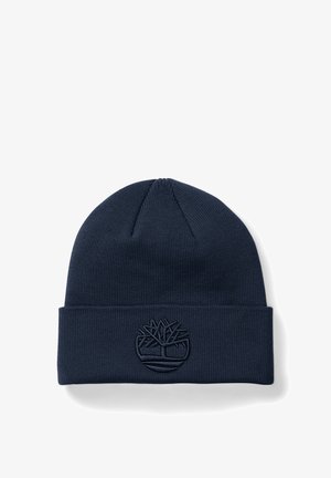 Beanie a maglia blu navy con risvolto, caratterizzato da un logo ad albero in rilievo sul davanti, realizzato in un materiale morbido e testurizzato.