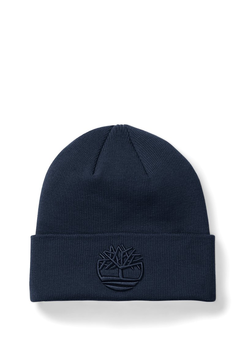 Marinblå stickad mössa med uppvikt kant, med en präglad trädlogotyp framtill, tillverkad av ett mjukt, texturerat material.