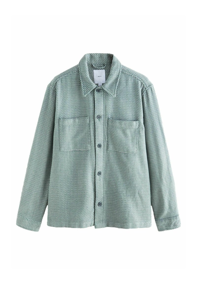 Green button-up shirt with a dotted pattern, featuring two chest pockets, a classic collar, and long sleeves with buttoned cuffs.