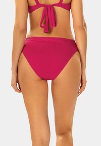 Różowe majtki bikini z wysokim stanem. Gładka tekstura, bez wzorów, oraz szeroki pas dla komfortu. Zawiązywane z tyłu w górnej części.