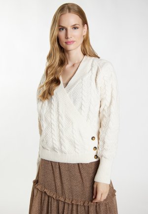 Pulover crem din tricot cu cabluri, cu un design de înfoiat, având manșete dintr-un material elastic și trei butoane aurii pe lateral. Textură moale și croială lejeră.