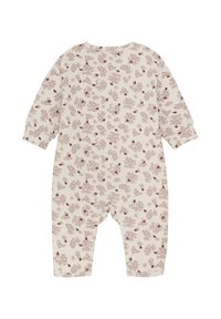 Combinaison à manches longues en beige avec un motif floral rouge et marron. Comprend des boutons-pression à l'arrière pour un habillage facile. Matériau en coton doux.