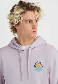 Light purple hoodie with a front graphic of a sunset over water. Features a drawstring hood and soft texture.